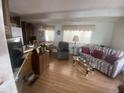 Open-concept living area with laminate flooring and neutral decor at 1147 S Sioux Dr, Apache Junction, AZ 85119