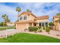 Charming two-story home featuring a well-manicured lawn, desert landscaping, and a two-car garage at 11731 N 91St Pl, Scottsdale, AZ 85260