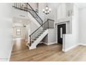 Grand entryway with wood floors, a staircase, and views into multiple living spaces at 13383 N 101St Way, Scottsdale, AZ 85260