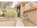Inviting entryway featuring a stone walkway and a large arched window above the front door at 13383 N 101St Way, Scottsdale, AZ 85260