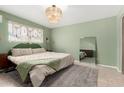 Serene bedroom featuring a comfortable bed, stylish rug, and decorative macrame wall hanging at 1340 E Golden Ln, Phoenix, AZ 85020