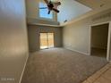 Spacious living room with vaulted ceiling and large sliding glass doors to patio at 15655 N 29Th St, Phoenix, AZ 85032