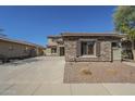 Charming single-story home showcasing stone accents, desert landscaping, and a private driveway at 16462 W Rowel Rd, Surprise, AZ 85387