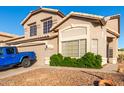 Charming home with well-maintained landscaping, a rock garden, and a peek at a blue Jeep parked outside the garage at 1701 E Yukon Dr, Phoenix, AZ 85024