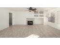The bright living room has neutral tile flooring, a cozy fireplace, and recessed shelving at 1701 E Yukon Dr, Phoenix, AZ 85024