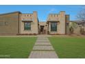 Striking front exterior showcasing modern architecture with stone accents, desert landscaping and inviting walkway at 17756 E Colt Dr, Queen Creek, AZ 85142