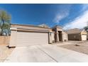 Attached two car garage and driveway for a single-story home at 1844 E Angelica St, Casa Grande, AZ 85122