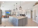 Open-concept layout featuring a gourmet kitchen with an oversized island and a view into the living area at 1960 Leisure World --, Mesa, AZ 85206