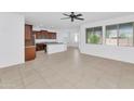 Open-concept living area with kitchen, dining, and abundant natural light from multiple windows at 2146 W Ian Dr, Phoenix, AZ 85041