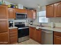Well-equipped kitchen with stainless steel appliances, wooden cabinets, and modern fixtures at 2460 E Main St # A2, Mesa, AZ 85213