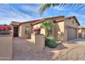 Attractive single-story house with tile roof, brick pavers, and manicured desert landscaping at 2611 E San Simeon Dr, Casa Grande, AZ 85194