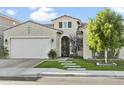 Charming home boasts a well-maintained lawn, arched entry, and attached two-car garage at 26844 N 73Rd Dr, Peoria, AZ 85383