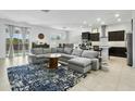 Open-concept living area with tile floors flows to the kitchen and dining space at 26844 N 73Rd Dr, Peoria, AZ 85383