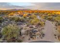 Sweeping aerial view of the desert home, highlighting its landscaped grounds and surrounding native desert environment at 30600 N Pima Rd # 76, Scottsdale, AZ 85266