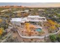 Expansive aerial view showcasing the outdoor living space, pool, and natural desert landscaping of the estate at 30600 N Pima Rd # 76, Scottsdale, AZ 85266