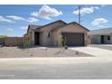Inviting single-level home features a well-kept front yard and a spacious two-car garage at 318 S San Fernando Ln, Casa Grande, AZ 85194