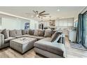 Open living room area showcasing a large sectional sofa and updated kitchen space at 3514 W Charleston Ave, Glendale, AZ 85308