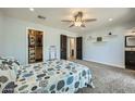 Bright main bedroom features carpeted floors, a ceiling fan, and a walk-in closet at 3514 W Charleston Ave, Glendale, AZ 85308