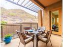 Cozy outdoor patio area with mountain views, stylish furniture, and dining set for four at 36600 N Cave Creek Rd # 17D, Cave Creek, AZ 85331