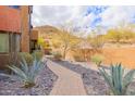 Scenic landscaped pathway leading to residences with desert vegetation and beautiful surroundings at 36600 N Cave Creek Rd # 17D, Cave Creek, AZ 85331