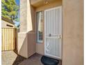 Close-up of front door with security screen, window, and desert-style landscaping at 3918 E Carson Rd, Phoenix, AZ 85042