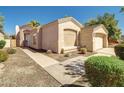 Inviting single-story home with manicured landscaping, a two-car garage, and a tile roof at 3918 E Carson Rd, Phoenix, AZ 85042