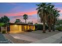 Inviting single-story home with a carport, desert landscaping, and a serene, colorful dusk backdrop at 4130 N 4Th Ave, Phoenix, AZ 85013