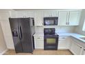 Kitchen featuring modern black appliances, white cabinets, and countertops at 4908 N 110Th Dr, Phoenix, AZ 85037