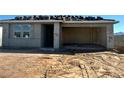 New home exterior shows an attached garage and the roof's clay tiling in the process of being installed at 5639 W Summerside Rd, Laveen, AZ 85339