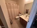 Full bathroom with a single sink vanity, toilet, and shower with curtain at 5684 S 237Th Dr, Buckeye, AZ 85326