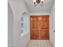 Foyer showcases a tiled floor, a view into other rooms through arched entryways, and double front doors at 6704 W Topeka Dr, Glendale, AZ 85308