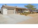 Charming single-story home with a spacious driveway and desert landscaping at 6926 E Culver St, Scottsdale, AZ 85257