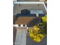 Aerial view of a single-story home with a dark roof and a landscaped front yard at 7316 W Carol Ave, Peoria, AZ 85345