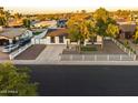 Charming single-story home with well-manicured landscaping, mature trees, and a white picket fence at 7316 W Carol Ave, Peoria, AZ 85345