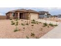 Charming single-story home featuring low-maintenance landscaping, a neutral color palette, and a two-car garage at 7342 E Hackamore Ln, San Tan Valley, AZ 85143