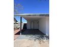 Attached carport featuring door to home with adjacent outdoor storage at 7426 W Beryl Ave, Peoria, AZ 85345