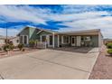 Charming single-story home with an attached carport and desert landscaping at 8500 E Southern Ave # 379, Mesa, AZ 85209