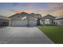 Charming single-story home featuring a three-car garage, stone accents and a well-manicured lawn at 854 S Del Rio Ct, Apache Junction, AZ 85120