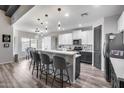 Modern kitchen featuring sleek white cabinets, stainless steel appliances, an eat-in island and pendant lighting at 854 S Del Rio Ct, Apache Junction, AZ 85120