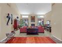 Spacious living room featuring high ceilings, large windows, and an open floor plan with a cozy fireplace at 8935 E Larkspur Dr, Scottsdale, AZ 85260