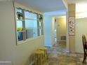 Bright hallway with functional decor and convenient access to other areas of the home at 10327 W Prairie Hills Cir, Sun City, AZ 85351