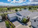 Gorgeous aerial view of a well-maintained home featuring a paved driveway, immaculate landscaping, and a golf course view at 11878 N Hershey St, Surprise, AZ 85388