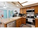 Bright kitchen with updated stainless steel appliances, sleek countertops, and ample cabinet space at 12001 N 53Rd Ave, Glendale, AZ 85304