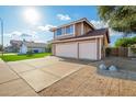 Charming two-story home with a well-manicured lawn, and an attached three car garage at 1401 E Brentrup Dr, Tempe, AZ 85283