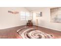 Living room with hardwood floors, neutral walls, a high ceiling, and bright natural light at 1401 E Brentrup Dr, Tempe, AZ 85283
