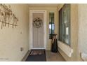 Welcoming front entry with a decorative wreath on the door, enhanced by natural light and neutral tones at 144 W Bahamas Dr, Casa Grande, AZ 85122