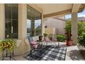 Inviting front porch featuring comfortable seating, stylish decor, and a relaxing outdoor ambiance at 144 W Bahamas Dr, Casa Grande, AZ 85122