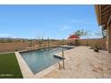 Resort-style pool featuring a captivating water feature and ample patio space for outdoor relaxation and entertaining at 14939 S 185Th Ave, Goodyear, AZ 85338