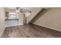 Open concept living room features wood-look flooring, breakfast bar, and stairway at 1545 E Sahuaro Dr # 12, Phoenix, AZ 85020