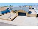 An aerial shot of a single-story home showcasing a desert front yard and an attached garage at 16010 N 64Th Dr, Glendale, AZ 85306